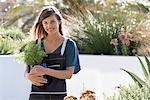 Portrait of a beautiful young woman gardening