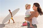 Happy young family enjoying on beach