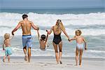 Rear view of a family walking on the beach