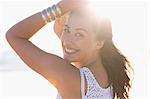 Smiling young woman posing on the beach