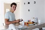 Close-up of a happy young man drinking coffee