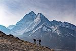 Trekkers climb a small peak above Dingboche in the Everest region in time to see the sunrise, with Ama Dablam in the distance, Himalayas, Nepal, Asia