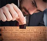 Businessman building a wall with small bricks