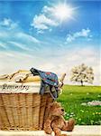 Wicker laundry basket with clothes against a blue sky