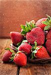 Fresh organic ripe wet strawberry on wooden table with water splash around
