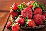 Fresh organic ripe strawberry on wooden table with water splash around