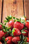 Fresh organic ripe strawberry on wooden table