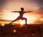 Man in a yoga position at sunset