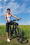 Fit woman going for bike ride on a sunny day in the countryside