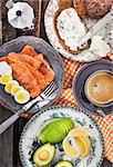 Breakfast with salted salmon, boiled eggs, avocado, bread, cream cheese and coffee