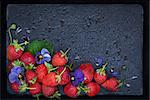 Fresh ripe strawberry on dark background with empty space (copy space), top view
