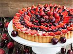 Summer tart with custard cream, fresh cherry and strawberry