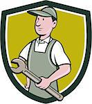Illustration of a repairman handyman worker wearing hat and overalls holding spanner wrench looking to the side viewed from front set inside shield crest done in cartoon style.