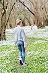 Young woman walking in park in spring