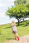 Rear view of young girl wearing dress outdoors