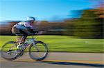 Blurred motion side view of cyclist cycling