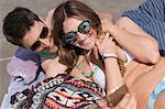 Couple on beach taking selfie smiling, Coney island, Brooklyn, New York, USA