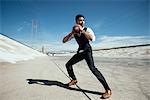 Businessman playing american football on Los Angeles river, California, USA