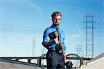 Businessman weightlifting, Los Angeles river, California, USA