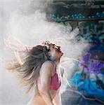 Woman throwing powder covered hair back smiling