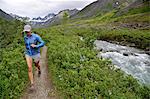 Woman running the Gold Mint Trail by Little Susitna River, Talkeetna Mountains near Hatcher Pass, Alaska, USA