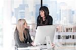 Businesswomen chatting in office