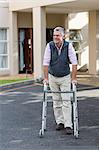 Senior man walking with a walking frame outside the hospital