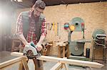 Carpenter using a machine in carpentry