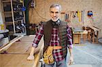 Senior carpenter looking at camera in workshop