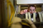 Technician working on broken server in server room