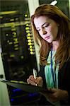 Technician preparing check list in server room