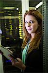 Portrait of technician preparing check list in server room