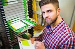 Portrait of technician preparing check list in server room