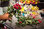 Close-Up of male florist arranging flower at his flower shop