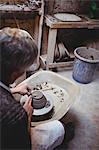 Craftsman preparing ceramic container in workshop