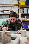 Concentrated man working at talbe in workshop