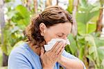 Close-up of mature woman sneezing