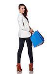 Shopping. The French way. Full length portrait of happy young woman with shopping bags on white background looking back