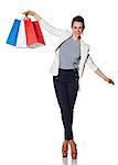 Shopping. The French way. Full length portrait of happy young woman with French flag colours shopping bags balancing on white background