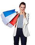 Shopping. The French way. Portrait of pensive young woman with French flag colours shopping bags on white background