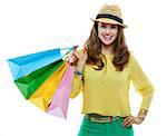 Colourful shopping vibes. Portrait of smiling brunette woman in hat and bright clothes with colorful shopping bags on white background