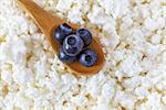cottage cheese and the wooden spoon with blueberries