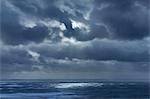 Dark clouds in overcast sky over ocean, Devon, United Kingdom