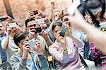 Audience using camera phones at technology conference