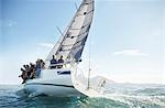 Retired friends on sailboat under blue sky