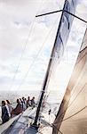 Friends sailing on sunny ocean