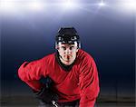 Portrait confident hockey player in red uniform