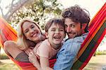 Family relaxing on hammock, portrait