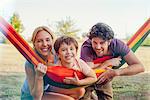 Family relaxing together outdoors, portrait