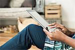 Close-up of woman using touch screen on digital tablet